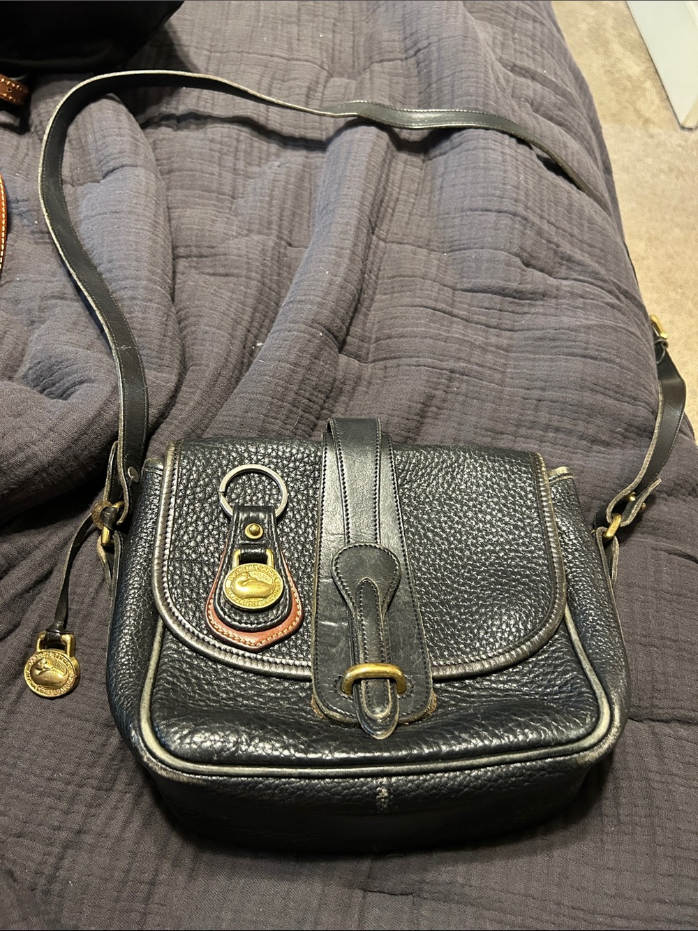 Dooney&Bourke black leather crossbody with original brass logo tag and keychain